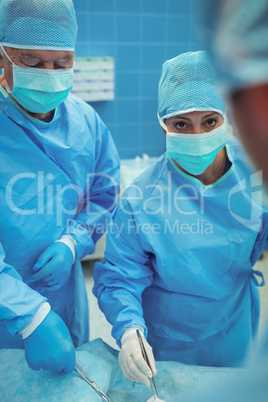 Team of surgeons performing operation in operation theater