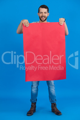 Handsome man holding a red blank placard