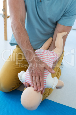 Paramedic demonstrating resuscitation on a infant dummy