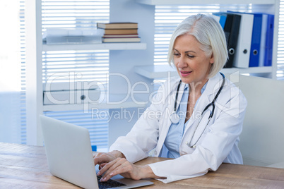 Female doctor working on her laptop