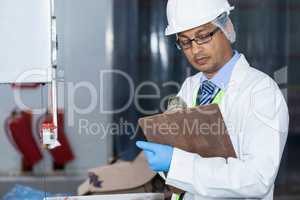 Technicians examining meat band saw