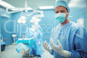 Portrait of male surgeon wearing surgical mask in operation theater