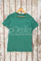 Green t-shirt with pocket on hanger