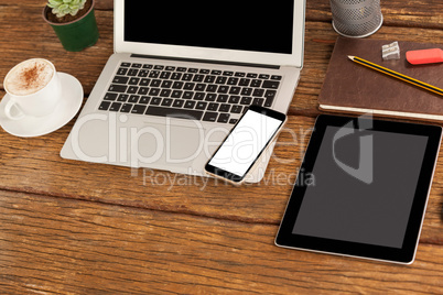 Laptop, smartphone and digital tablet with cup of coffee