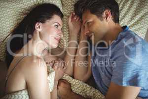 Romantic couple relaxing on bed