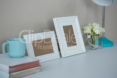 Picture frames, coffee cup with and flower vase