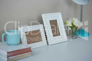 Picture frames, coffee cup with and flower vase