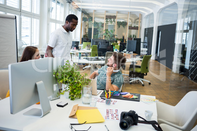 Graphic designers interacting at their desk