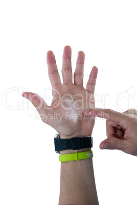 Man hand wearing watch and fitness band