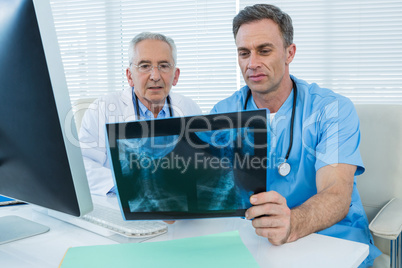 Surgeon and doctor discussing x-ray report