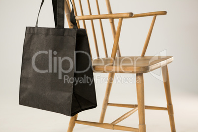 Black bag hanging on a wooden chair