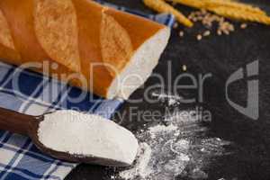 Bread loaf with wheat grains and flour