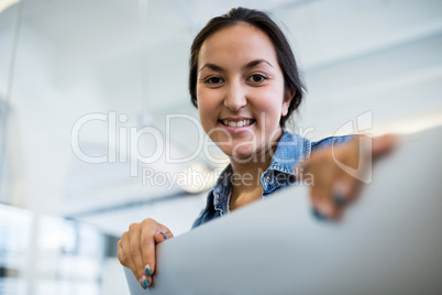 Smiling graphic female designers at desk