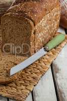 Sliced loaf of bread with knife
