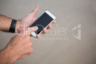 Close-up of mans hands using mobile phone