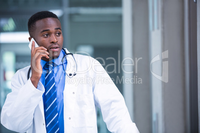 Tensed doctor talking on mobile phone