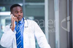Tensed doctor talking on mobile phone