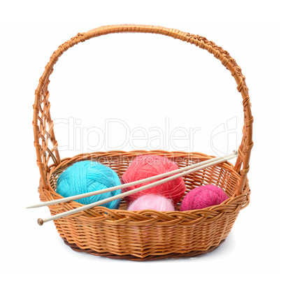 skeins of yarn and knitting needles isolated on a white backgrou