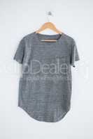 Grey t-shirt hanging on wall