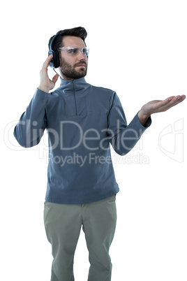 Man in protective glasses doing hand gestures while listening to headphones