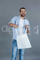 Happy man holding an empty shopping bag