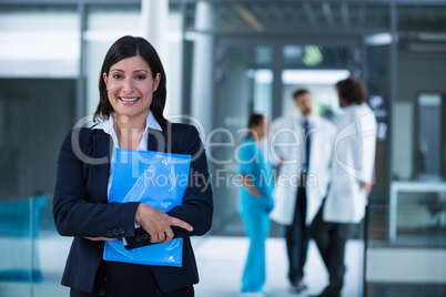 Confident businesswoman holding a file