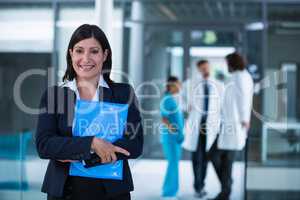 Confident businesswoman holding a file