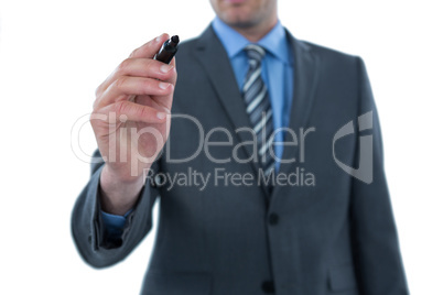 Businesswoman writing on digital screen against white background