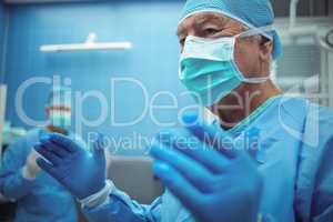 Male surgeon wearing surgical mask in operation theater