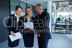 Happy businesspeople discussing over a report