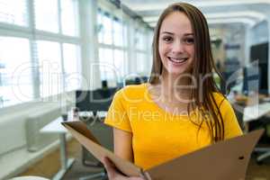 Female business executive reading file in office