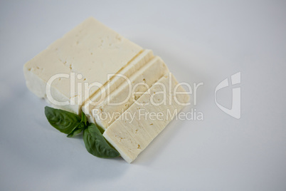 Blocks of cheese with herbs on white background