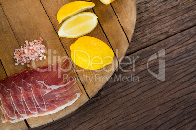 Sweet lime and meat on wooden board