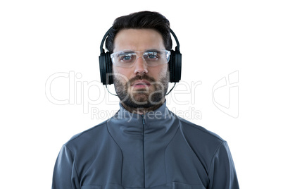 Man wearing protective glasses listening to headphones