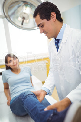 Doctor examining a female patients leg