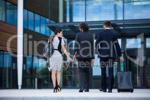 Businesswoman with colleagues walking