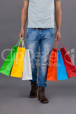 Man holding colourful shopping bags