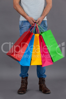 Man holding colourful shopping bags