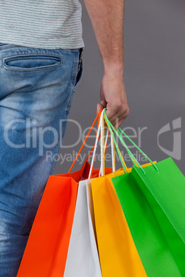 Man holding colourful shopping bags