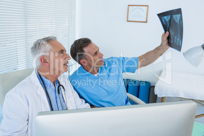 Surgeon and doctor discussing x-ray report