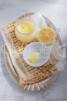 Lemon kurd with a spoon served on a table