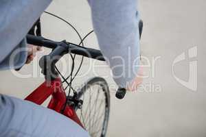 Mid section of man riding bicycle