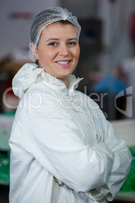 Female butcher standing with arms crossed