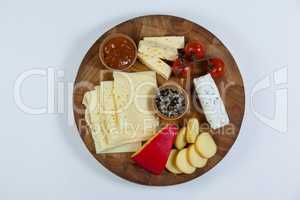 Different types of cheese, tomatoes and bowl of jam