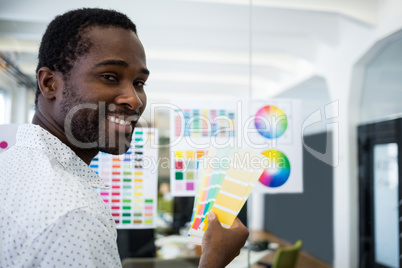 Graphic designer holding color swatch