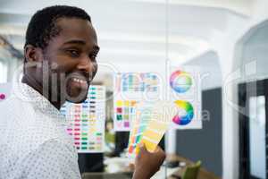 Graphic designer holding color swatch