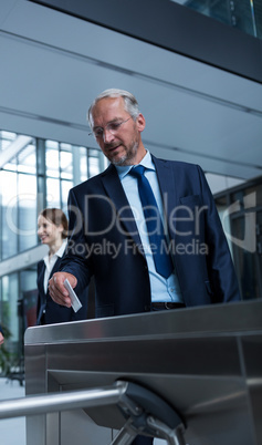 Businessman scanning his card at turnstile gate