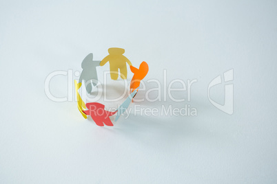 Circle of multicolored paper cut-out figures