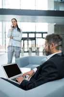 Businessman sitting and using laptop