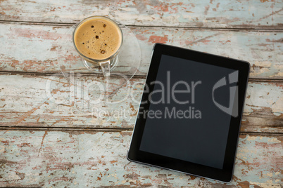 Digital tablet and cup of coffee